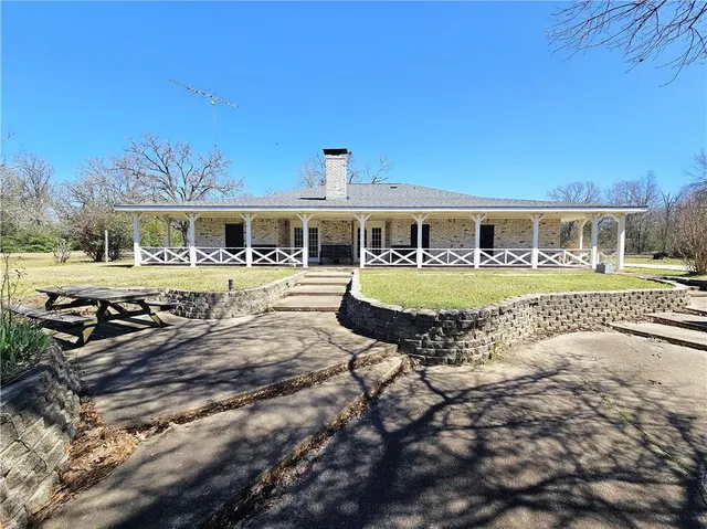 a view of a house with yard and sitting area