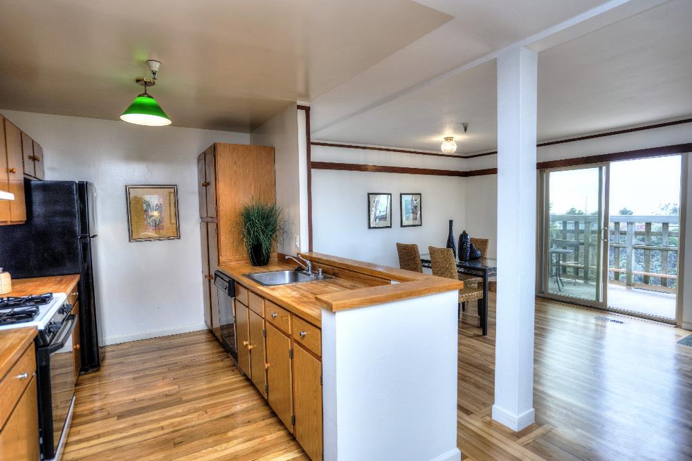 534 Monterey Road Pacifica, CA 94044 - Photo 8 of 20 a kitchen with a stove and a wooden floor