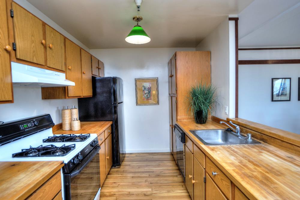 534 Monterey Road Pacifica, CA 94044 - Photo 10 of 20 a kitchen with stainless steel appliances granite countertop a sink a stove and a refrigerator