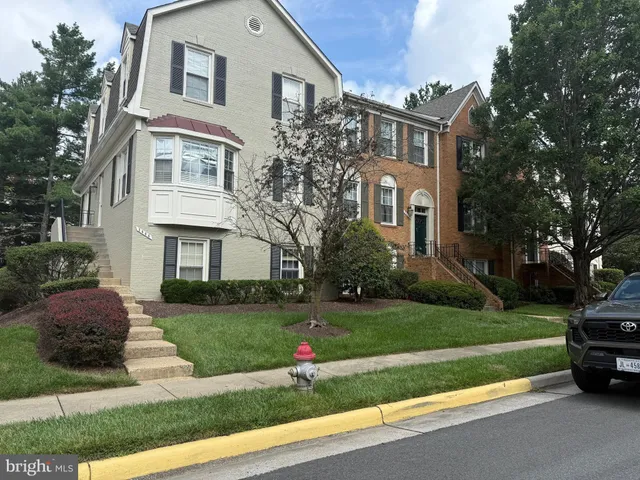 a car parked in front of a white house