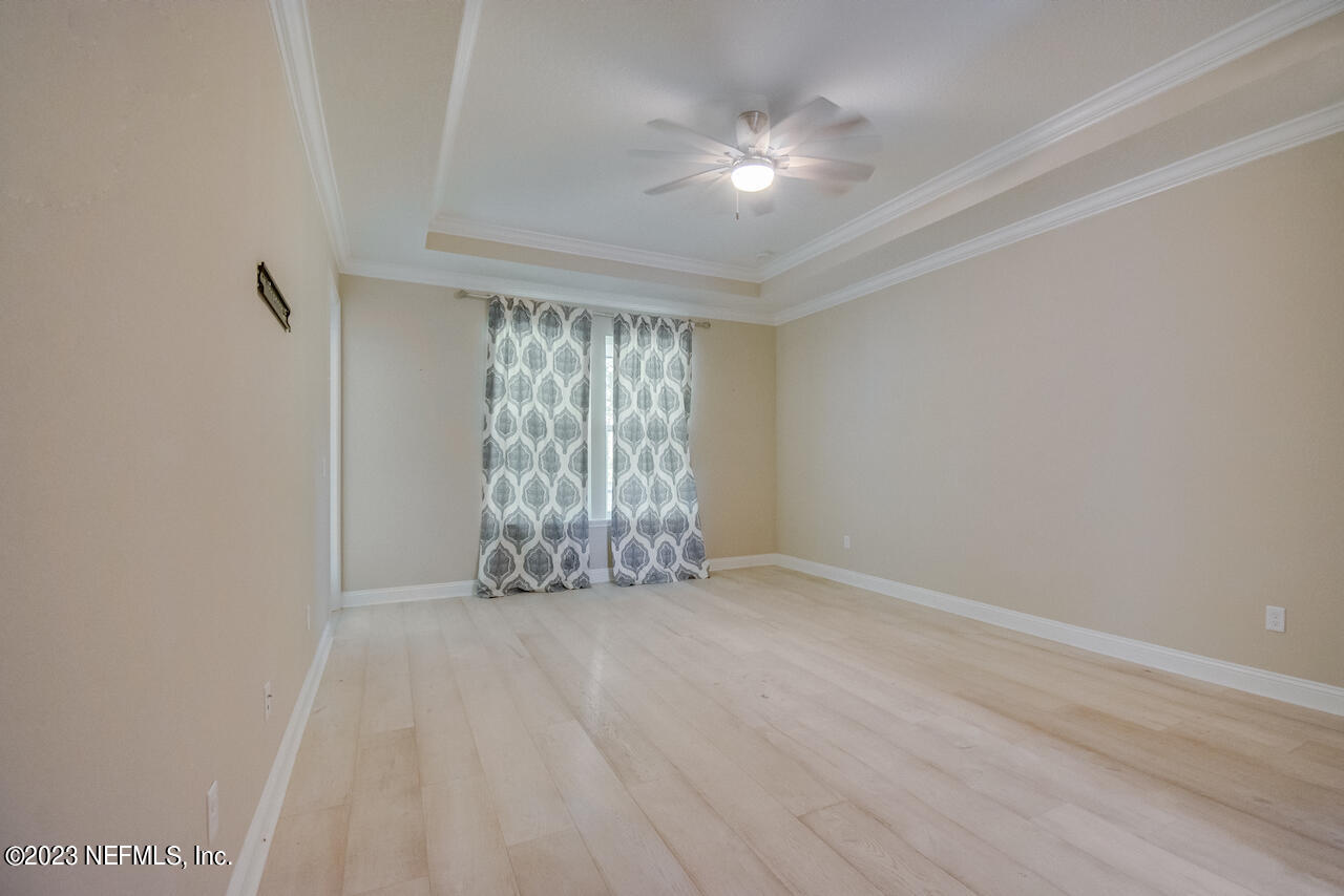 233 Aspinwall Parkway St. Augustine, FL 32095 - Photo 11 of 31 an empty room with windows and chandelier fan