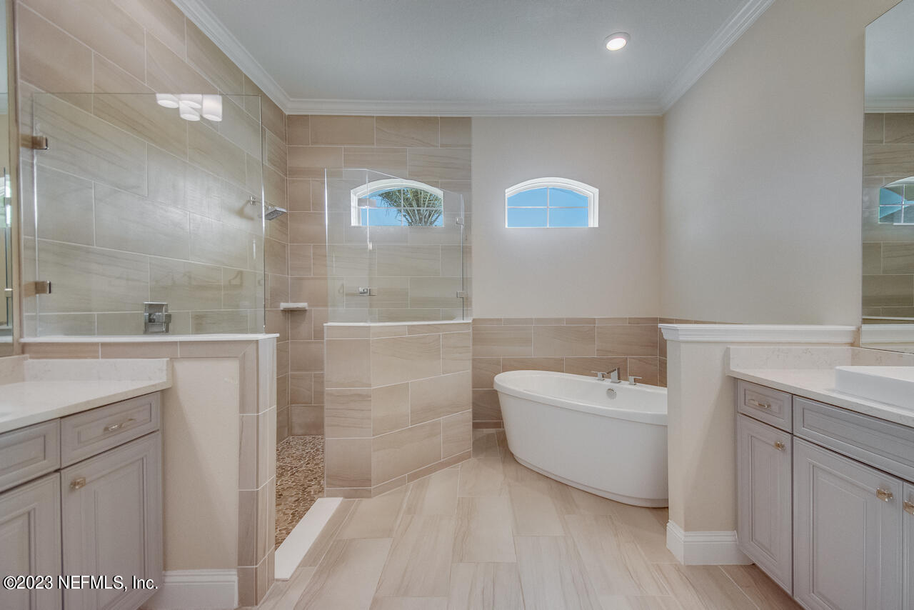 233 Aspinwall Parkway St. Augustine, FL 32095 - Photo 12 of 31 a spacious bathroom with a tub sink and mirror