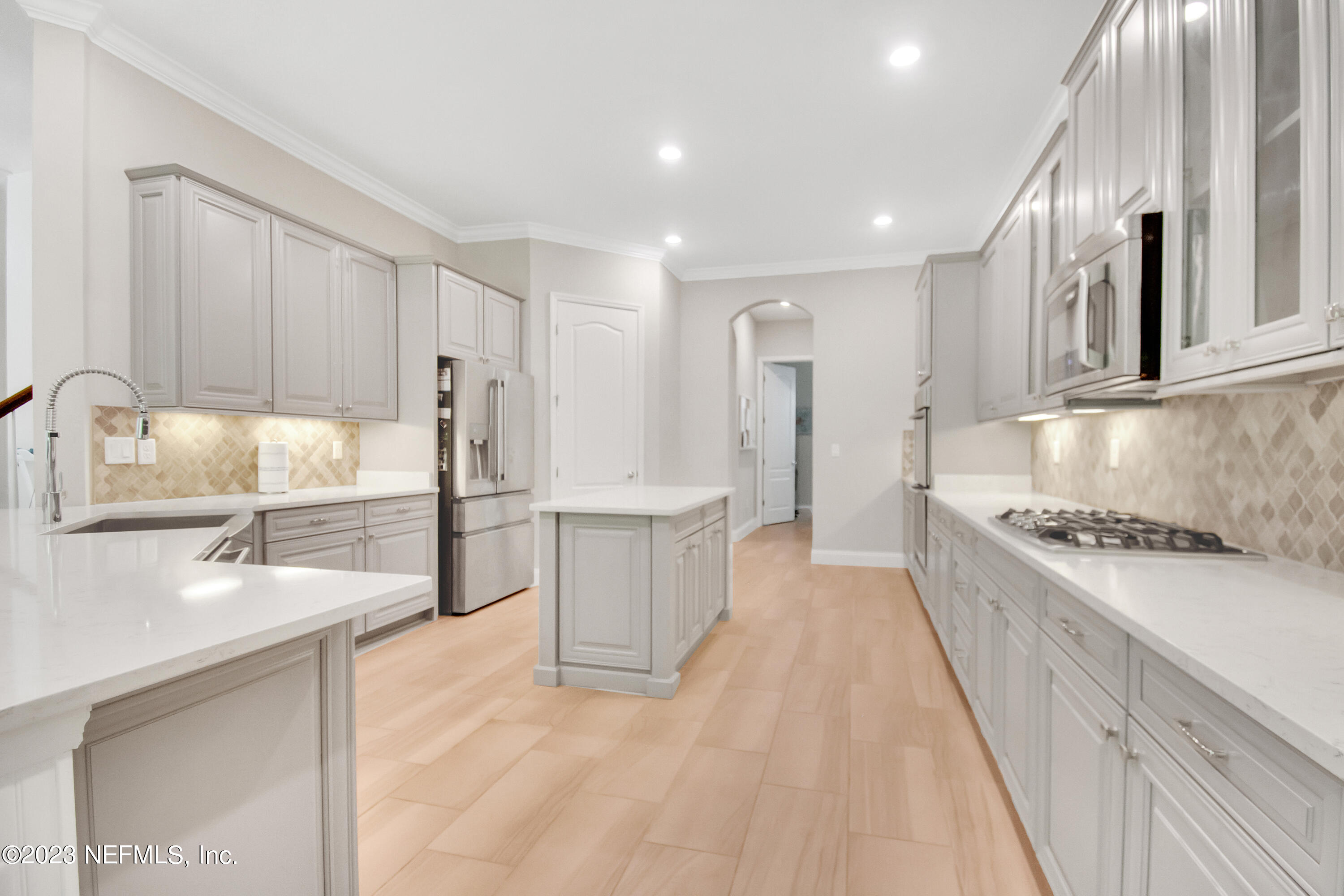 233 Aspinwall Parkway St. Augustine, FL 32095 - Photo 6 of 31 a kitchen with granite countertop a sink stove and refrigerator