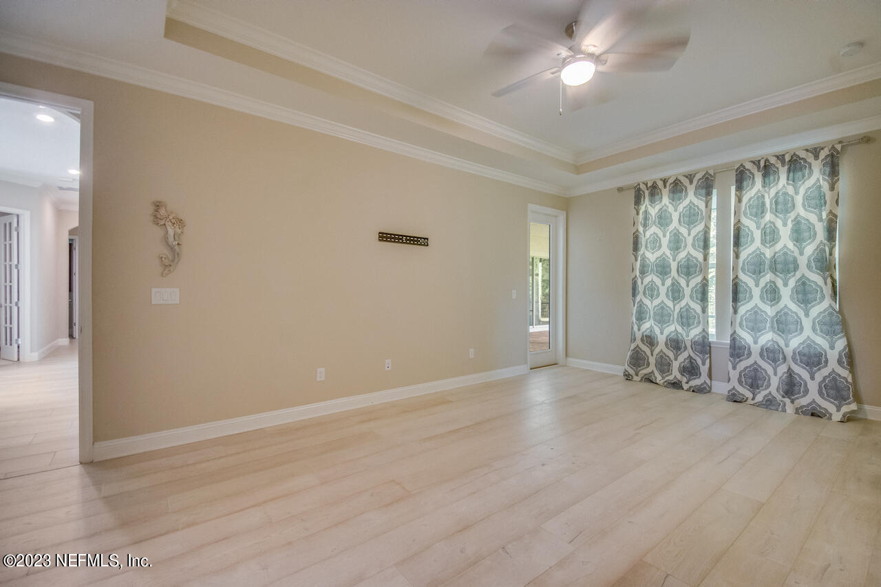 233 Aspinwall Parkway St. Augustine, FL 32095 - Photo 9 of 31 wooden floor in an empty room with a window