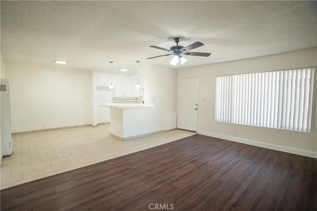 a kitchen with white cabinets and appliances