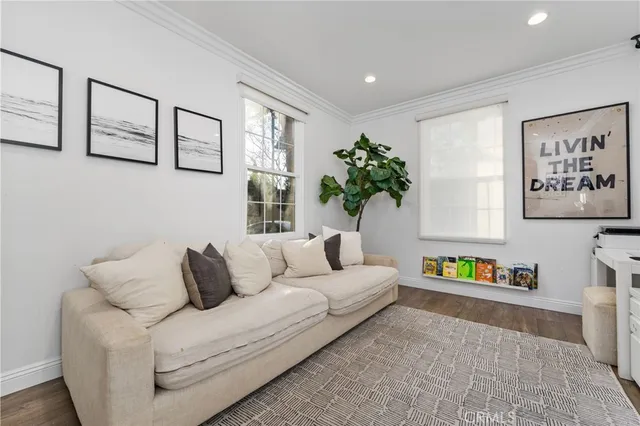 a living room with furniture and painting on the wall