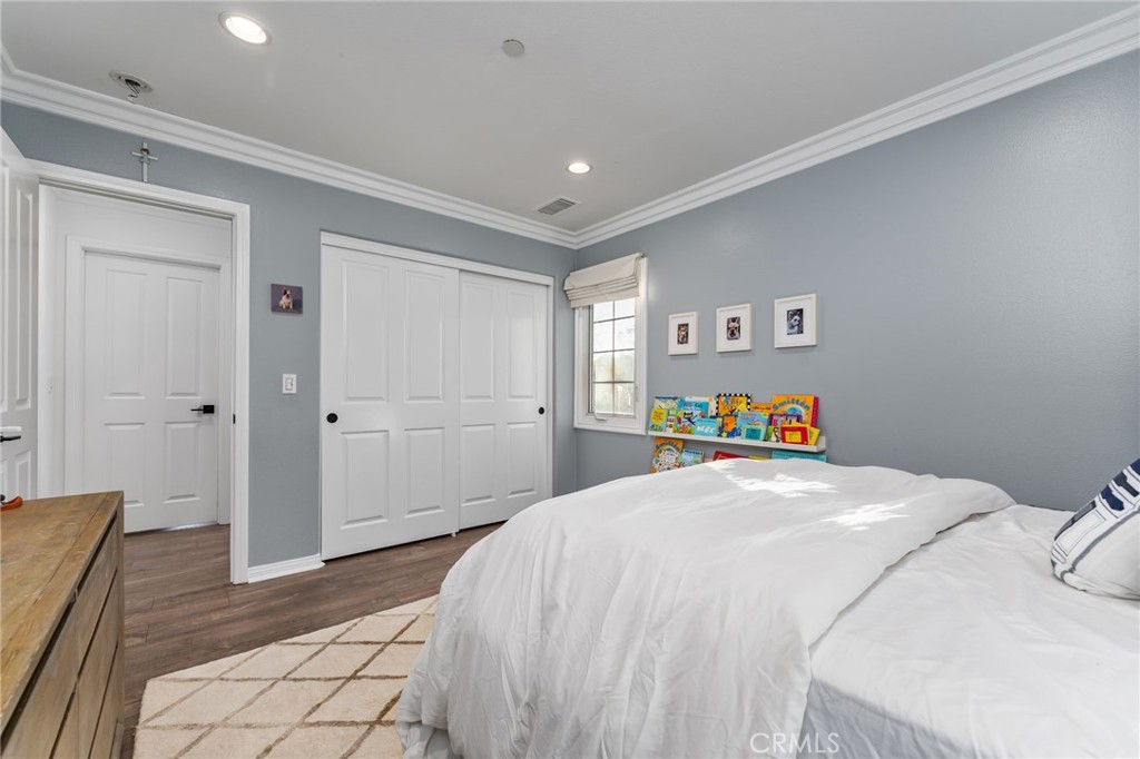 10 Bower Tree Irvine, CA 92603 - Photo 22 of 37 a bed room with a bed and a walk in closet
