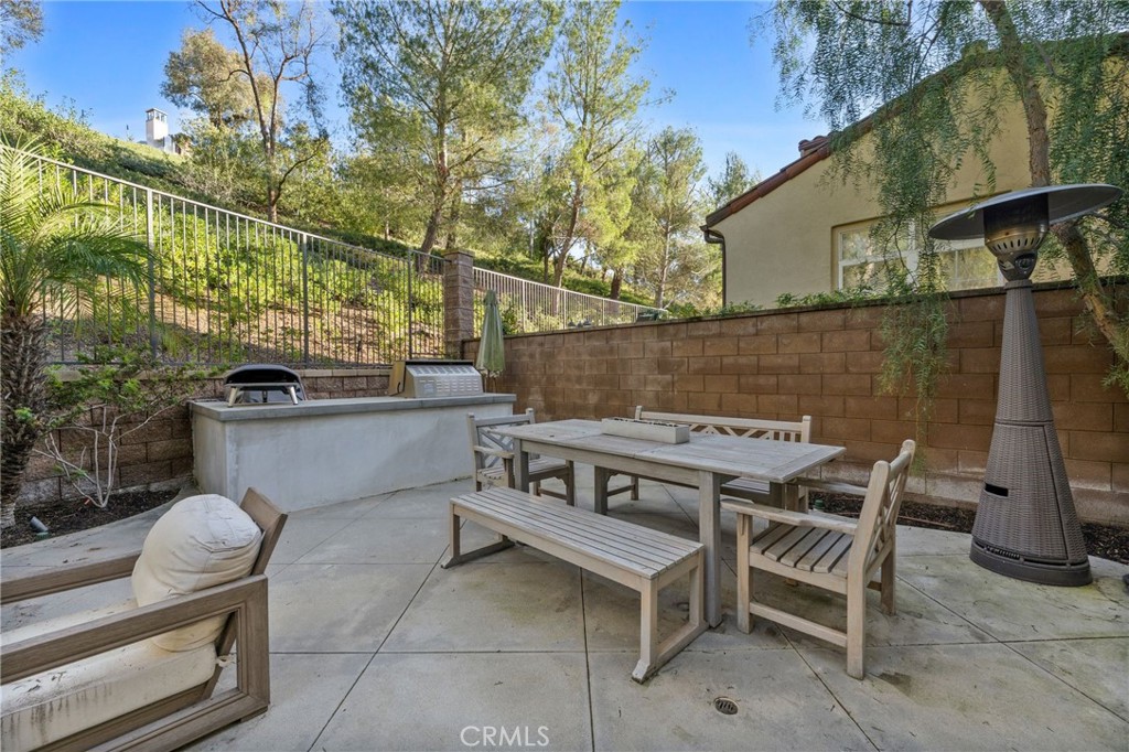 10 Bower Tree Irvine, CA 92603 - Photo 30 of 37 a view of a patio with table and chairs with wooden fence