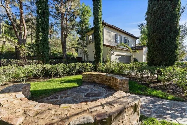 an aerial view of a house with a yard and large trees