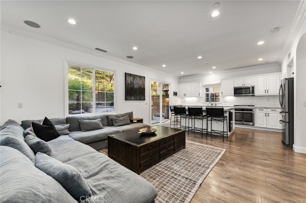 10 Bower Tree Irvine, CA 92603 - Photo 8 of 37 a living room with furniture kitchen view and a flat screen tv