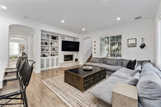 a living room with furniture a rug and a flat screen tv