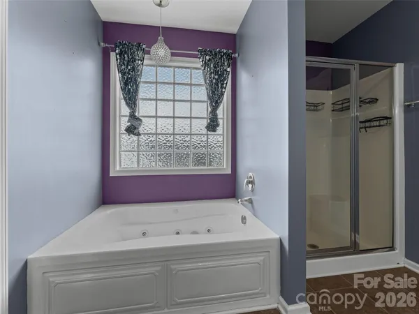 a view of bathroom with a bathtub and shower