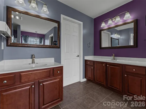 a bathroom with a sink vanity and mirror