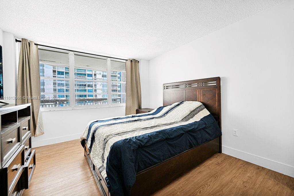 18041 Biscayne Boulevard, Unit 1201 Aventura, FL 33160 - Photo 12 of 42 Another view of the bedroom showcasing space and modern condo design, ideal for Aventura high-rise living.