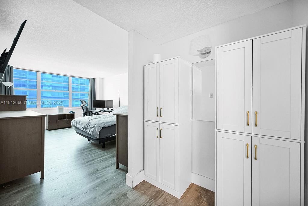 18041 Biscayne Boulevard, Unit 1201 Aventura, FL 33160 - Photo 14 of 42 Chic master suite with direct balcony access, water views, and generous closet space for modern comfort.