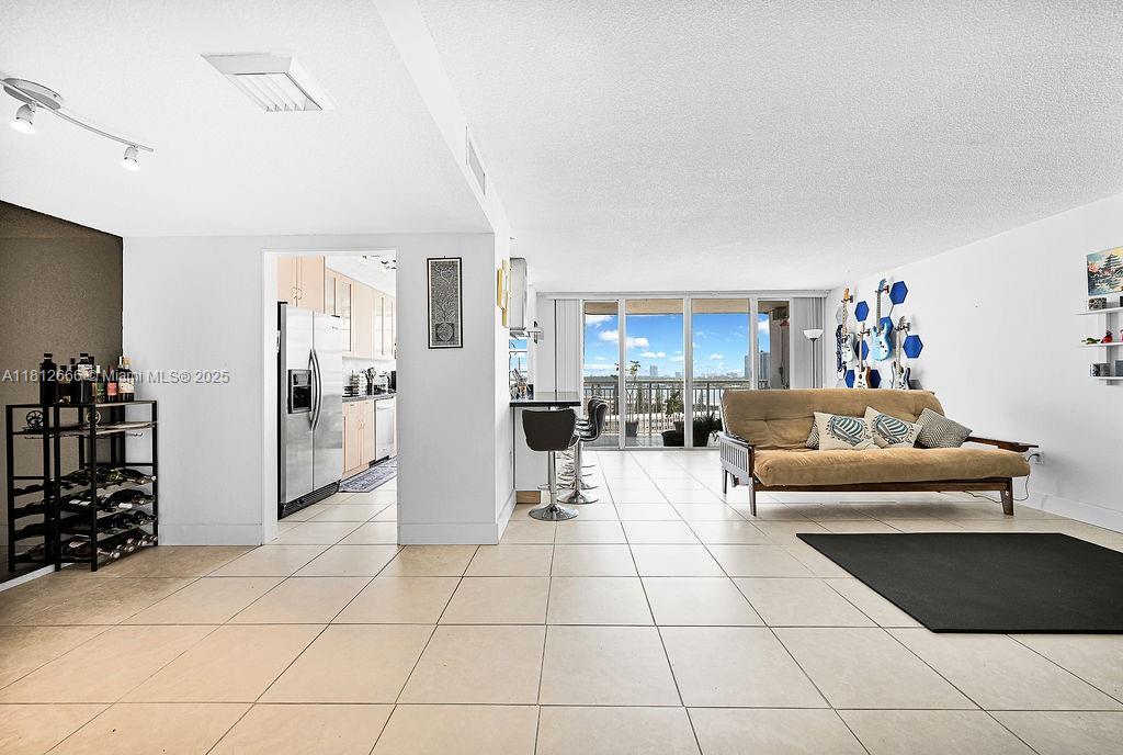 18041 Biscayne Boulevard, Unit 1201 Aventura, FL 33160 - Photo 2 of 42 Bright and open living area featuring floor-to-ceiling windows, natural light, and seamless flow to the balcony. Ideal for modern condo living in Aventura.
