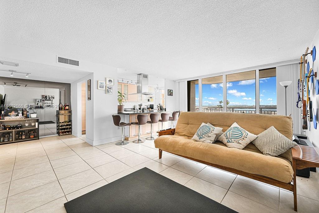 18041 Biscayne Boulevard, Unit 1201 Aventura, FL 33160 - Photo 3 of 42 Expansive open-concept living room with stylish finishes and panoramic water views, creating a luxurious yet comfortable ambiance.