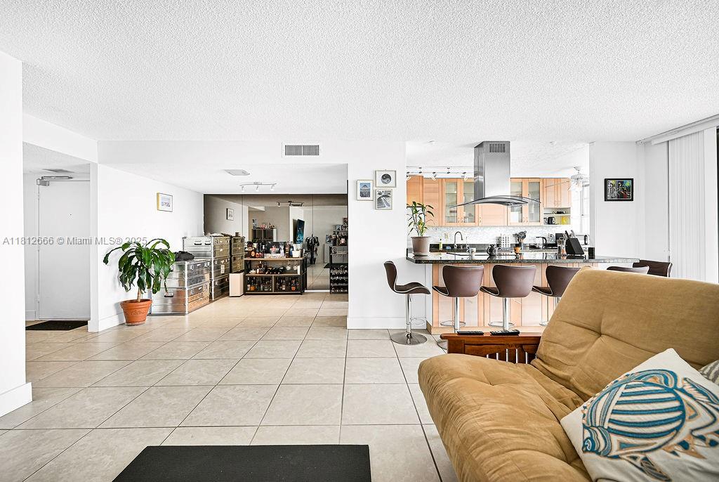 18041 Biscayne Boulevard, Unit 1201 Aventura, FL 33160 - Photo 6 of 42 Spacious great room layout connecting kitchen, dining, and living areas — designed for open flow and natural lighting.
