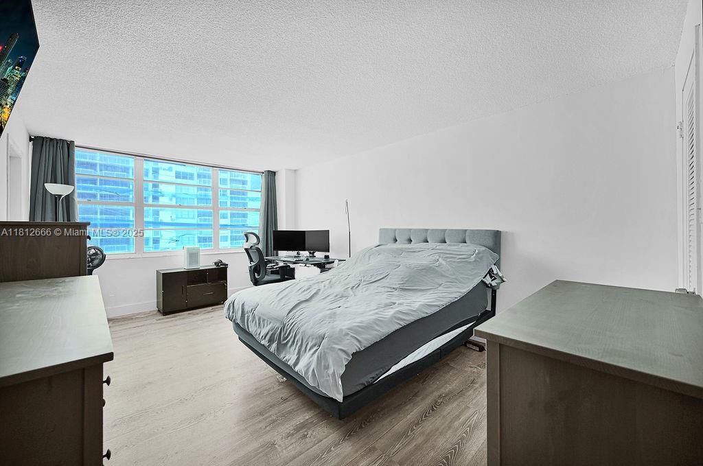 18041 Biscayne Boulevard, Unit 1201 Aventura, FL 33160 - Photo 7 of 42 Inviting primary bedroom with large windows showcasing Intracoastal views and ample closet space — your private retreat in Aventura.