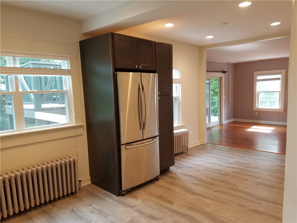 49 Merton Road, Unit 2 Newport, RI 02840 - Photo 11 of 42 Kitchen view to Living Room/Dining Area & sliders to wrap around porch