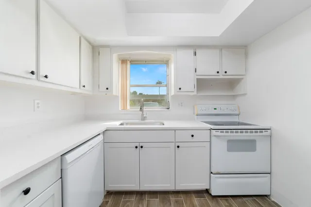 a kitchen with a sink and a refrigerator
