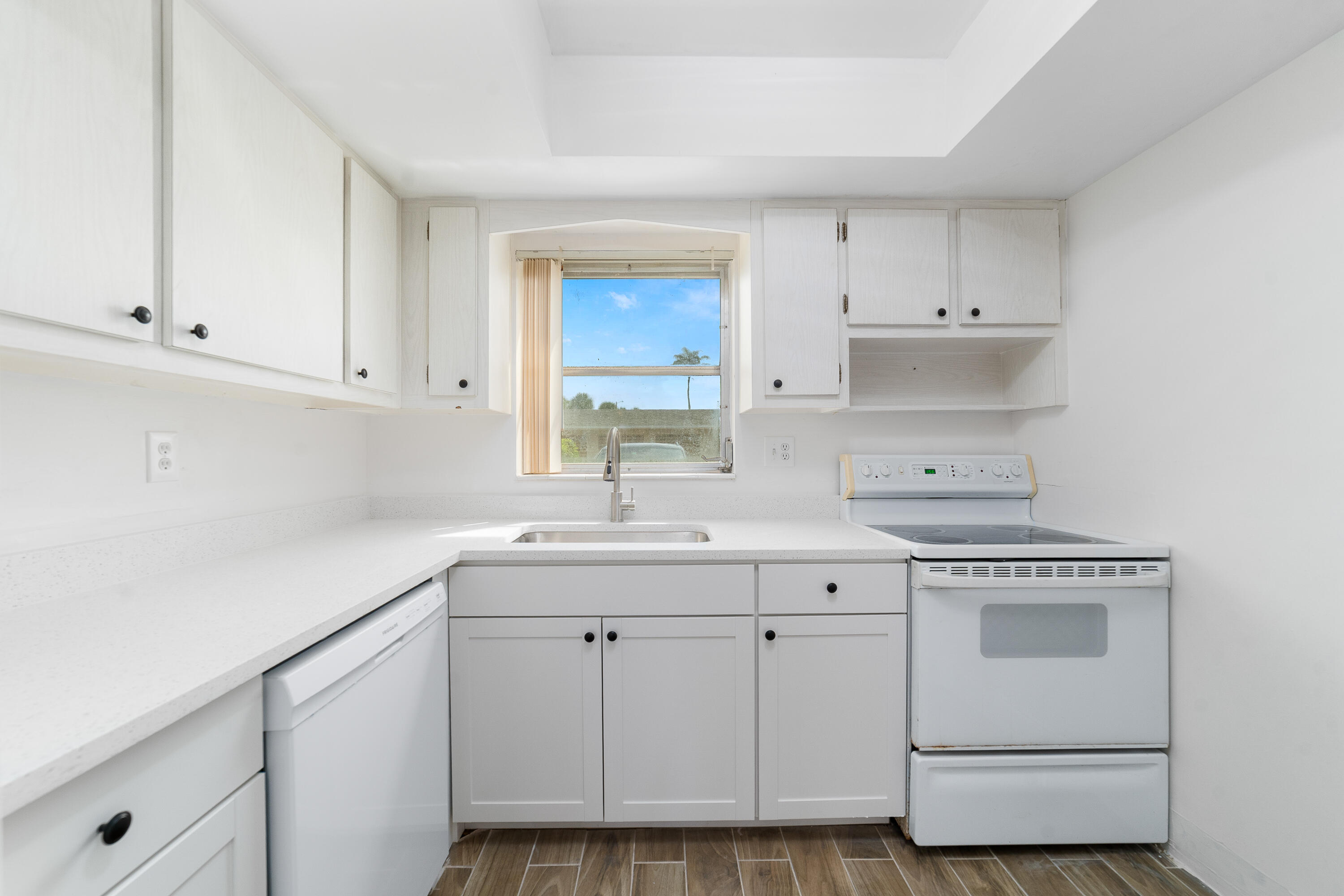 2567 Dudley Drive West, Unit F West Palm Beach, FL 33415 - Photo 14 of 41 a kitchen with white cabinets and white appliances