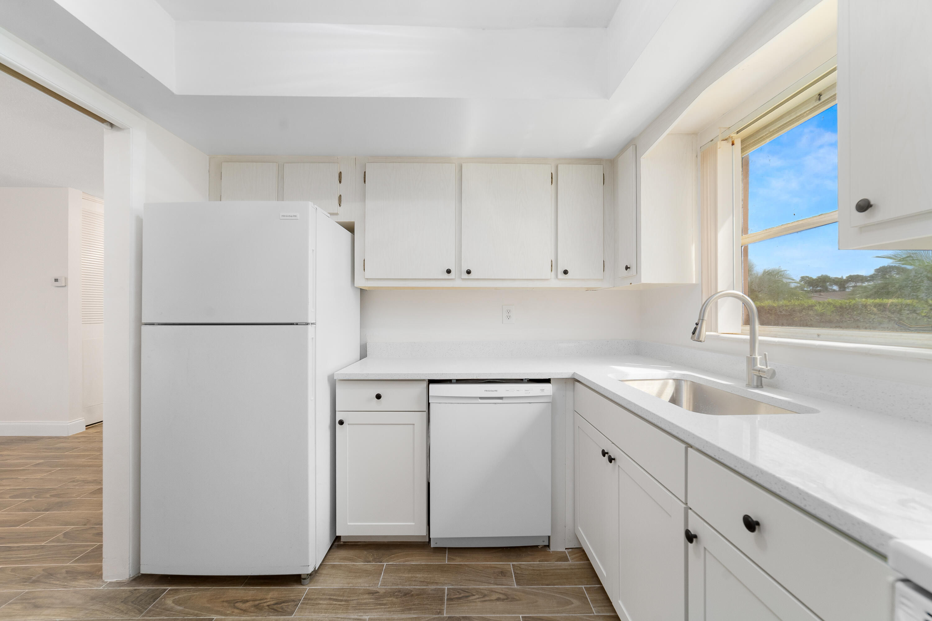 2567 Dudley Drive West, Unit F West Palm Beach, FL 33415 - Photo 15 of 41 a kitchen with a sink and a refrigerator