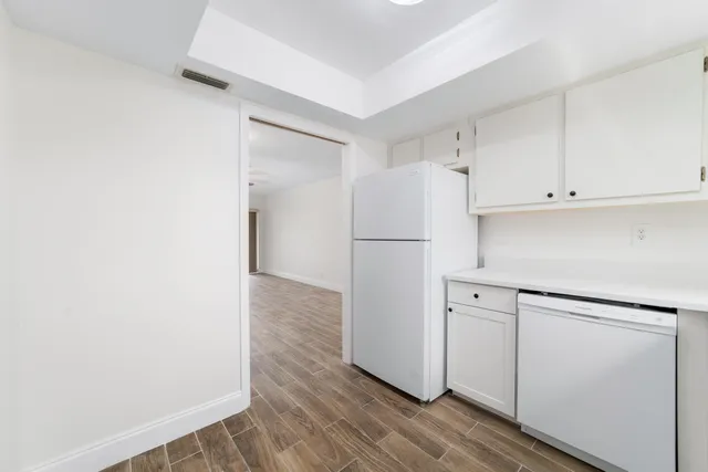 a room with a sink cabinets and a window