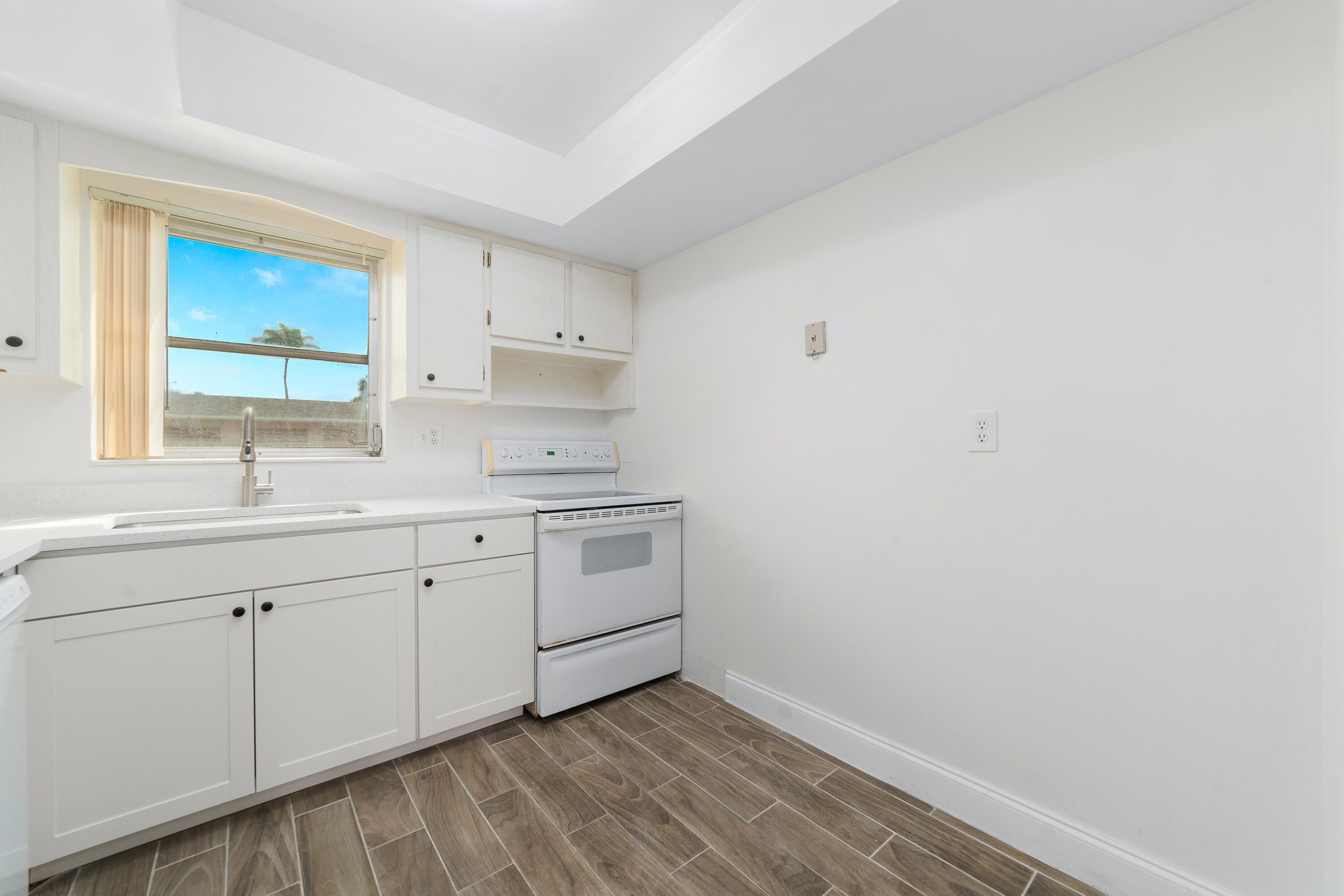 2567 Dudley Drive West, Unit F West Palm Beach, FL 33415 - Photo 17 of 41 a room with a sink cabinets and a window