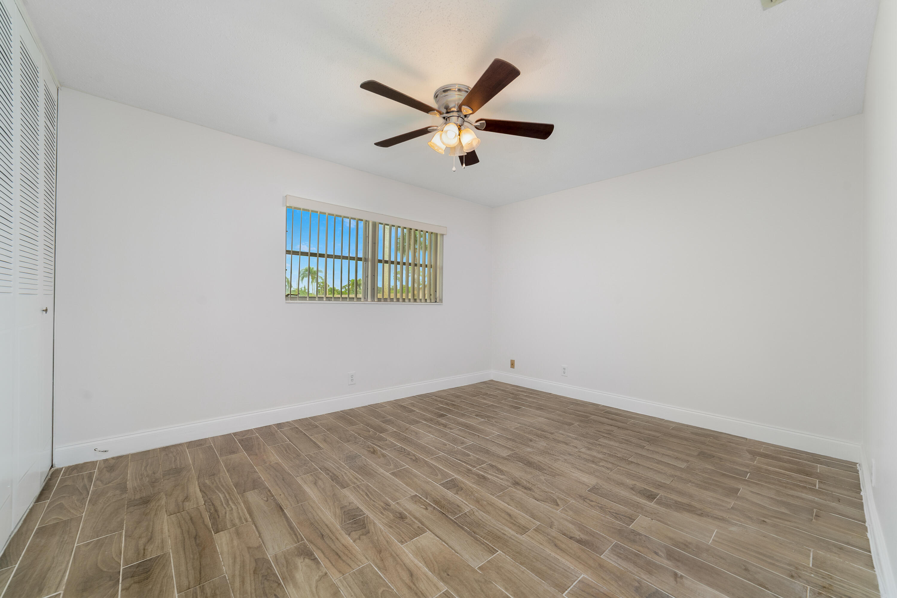 2567 Dudley Drive West, Unit F West Palm Beach, FL 33415 - Photo 18 of 41 a view of empty room with wooden floor