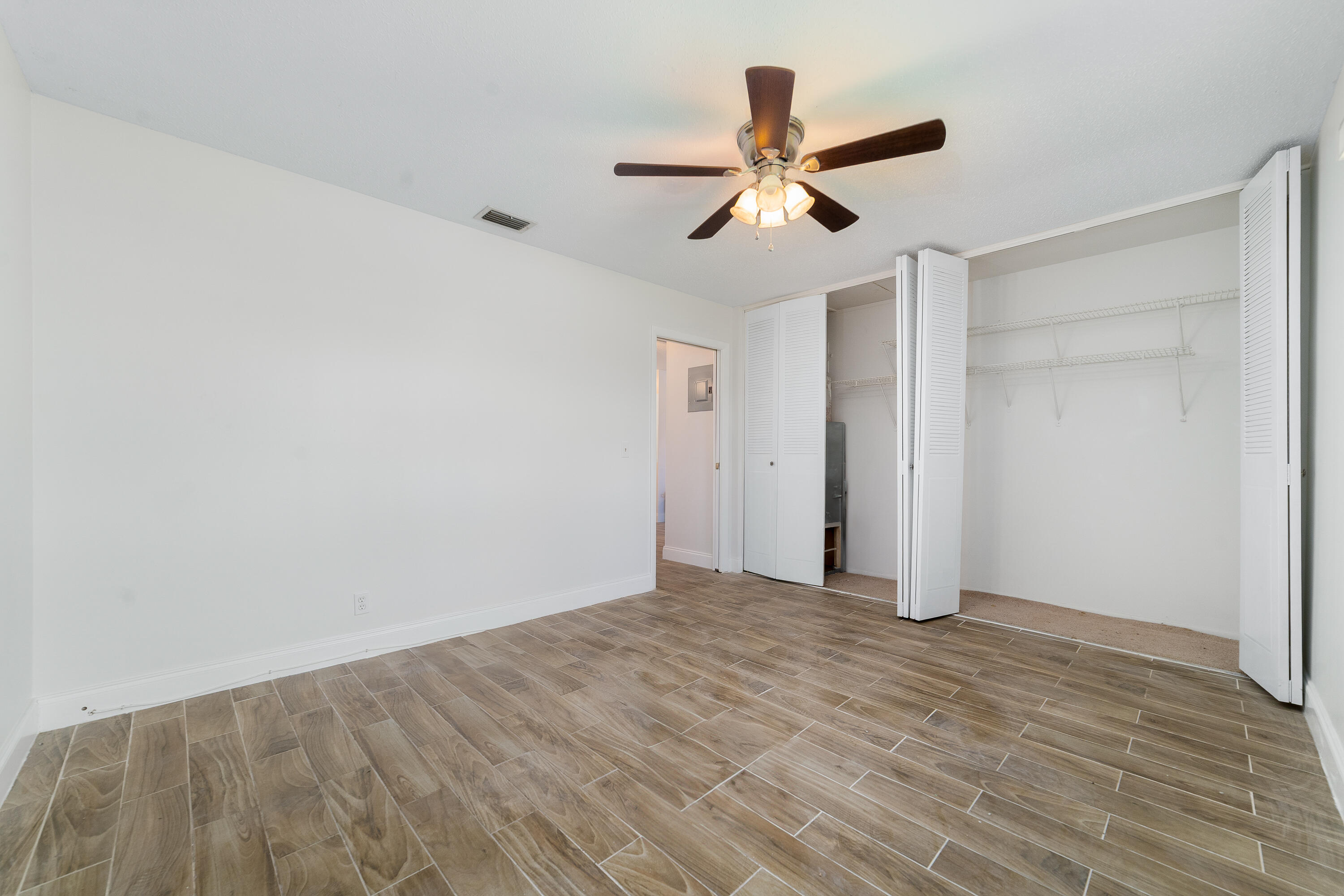 2567 Dudley Drive West, Unit F West Palm Beach, FL 33415 - Photo 20 of 41 a view of a big room with wooden floor and windows