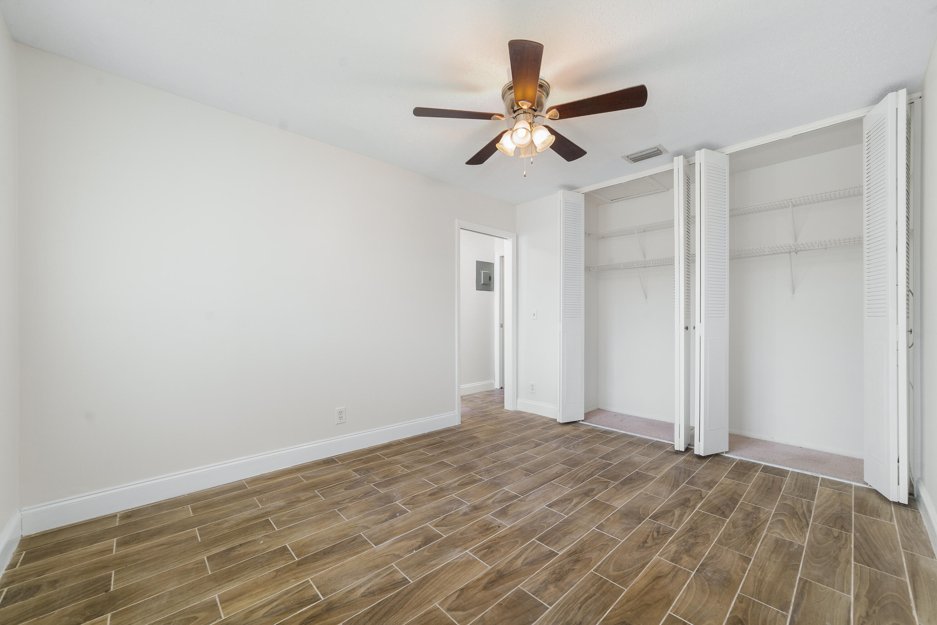 2567 Dudley Drive West, Unit F West Palm Beach, FL 33415 - Photo 25 of 41 a view of a big room with wooden floor and windows