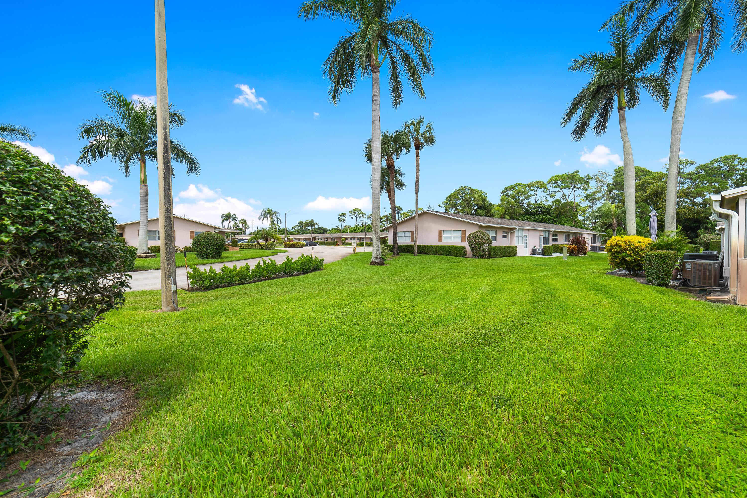 2567 Dudley Drive West, Unit F West Palm Beach, FL 33415 - Photo 31 of 41 a view of a swimming pool with a garden