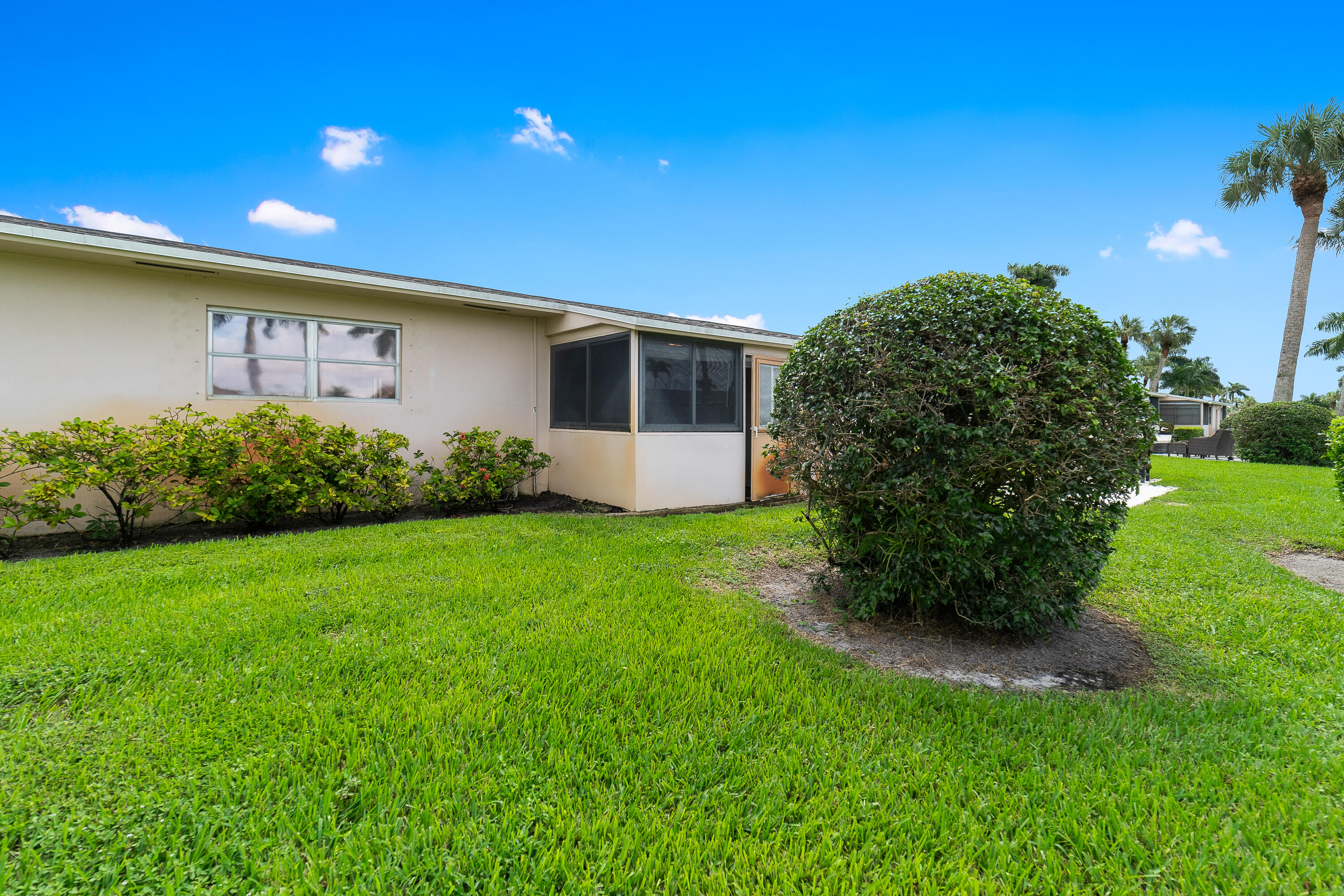 2567 Dudley Drive West, Unit F West Palm Beach, FL 33415 - Photo 33 of 41 a front view of a house with garden
