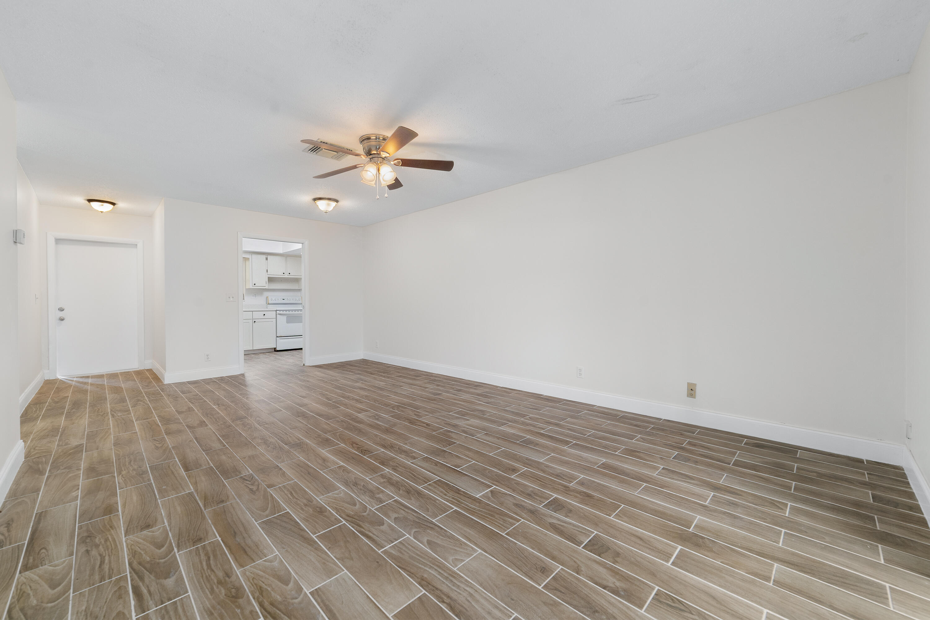 2567 Dudley Drive West, Unit F West Palm Beach, FL 33415 - Photo 10 of 41 a view of empty room with wooden floor and fan