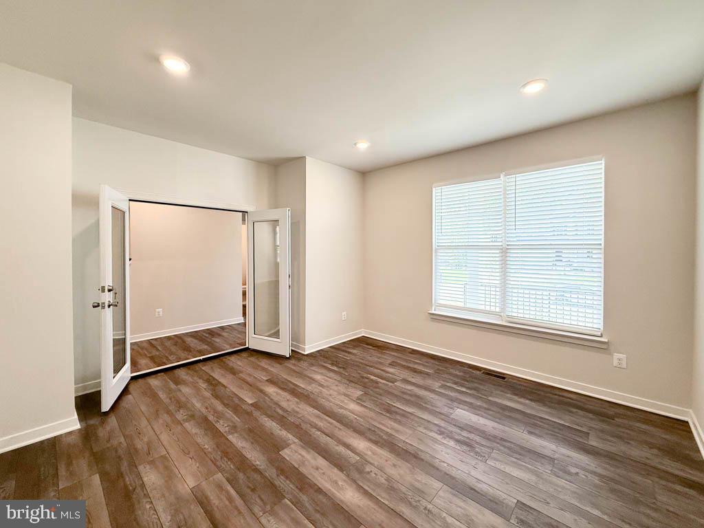 9213 Moldova Road Chesterfield, VA 23832 - Photo 17 of 51 an empty room with wooden floor and windows