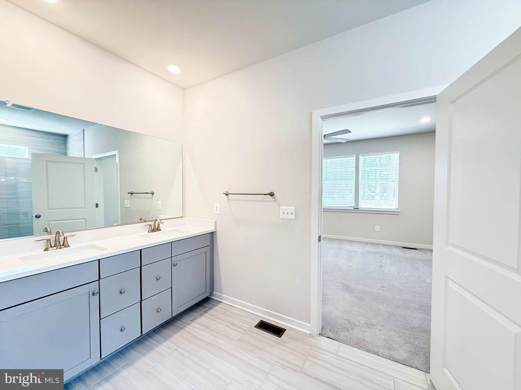 9213 Moldova Road Chesterfield, VA 23832 - Photo 27 of 51 a spacious bathroom with a double vanity sink a large mirror and a shower