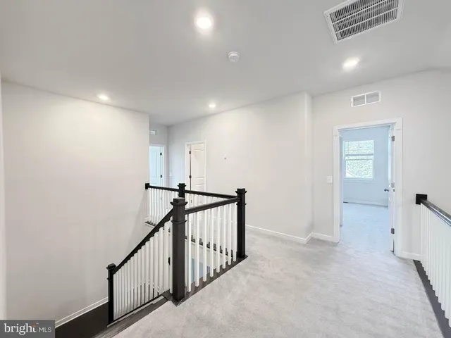 a view of a hallway with stairs