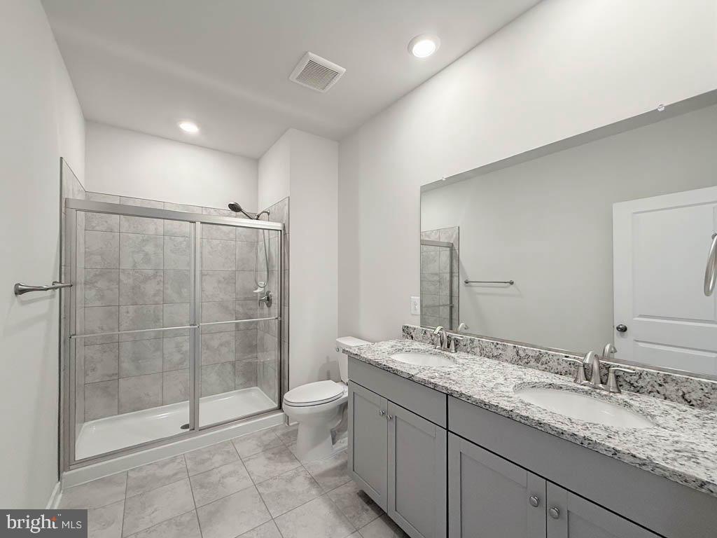 9213 Moldova Road Chesterfield, VA 23832 - Photo 35 of 51 a bathroom with a granite countertop sink a toilet and shower