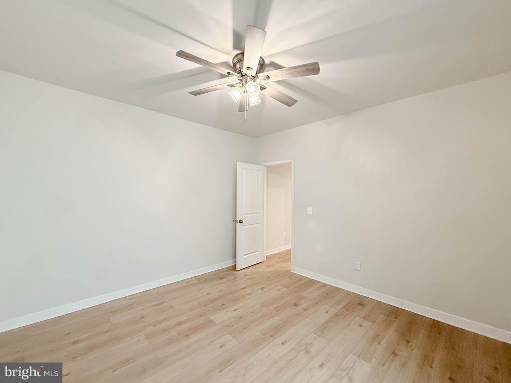 9213 Moldova Road Chesterfield, VA 23832 - Photo 40 of 51 an empty room with wooden floor fan and windows