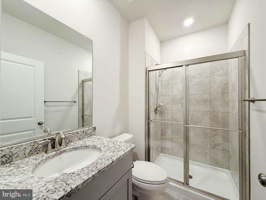 9213 Moldova Road Chesterfield, VA 23832 - Photo 41 of 51 a bathroom with a granite countertop sink toilet and shower