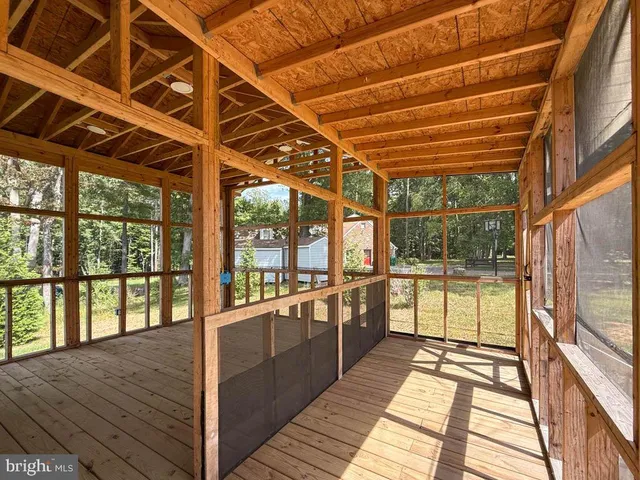 a view of porch with wooden floor