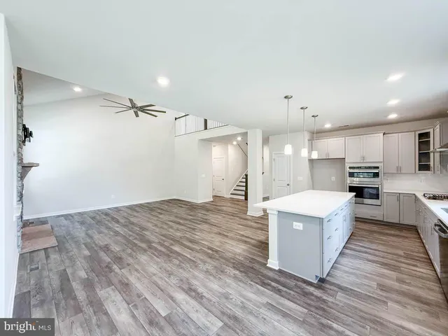 a view of kitchen with sink microwave and refrigerator