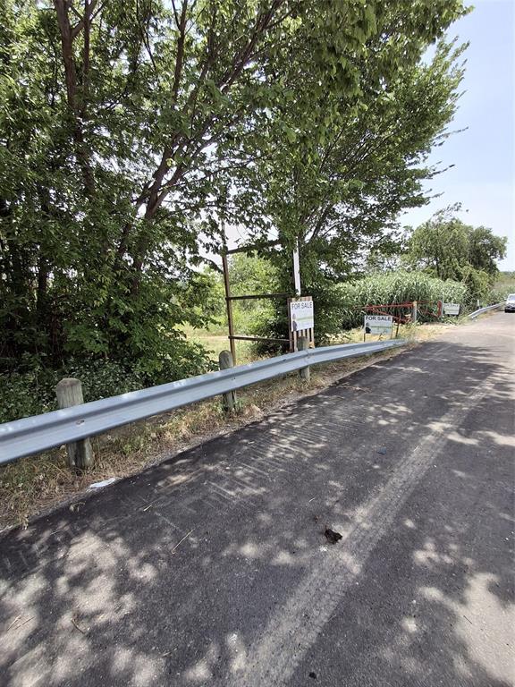 4700 West Davis Street Dallas, TX 75211 - Photo 2 of 3 a view of a green field with trees in the background