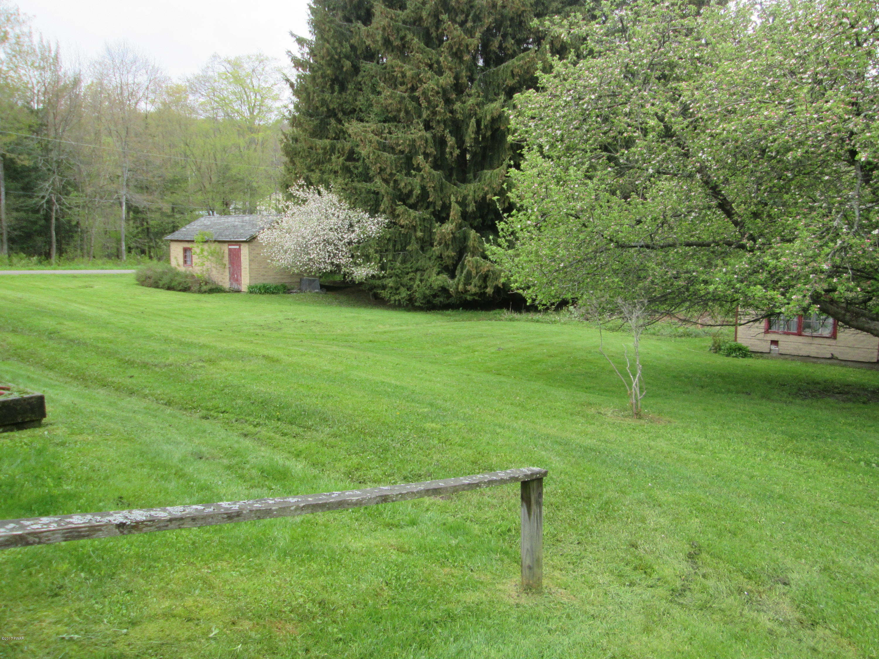 86 Beaver Hollow Road Lakewood, PA 18439 - Photo 23 of 30 a garden with trees in the background