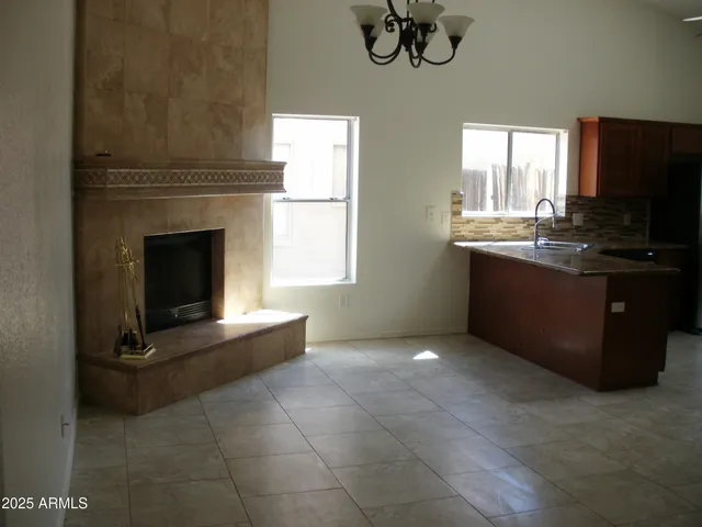 a kitchen with kitchen island granite countertop a stove top oven a sink and a window