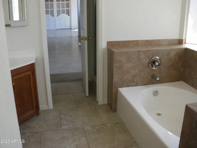 a bathroom with a tub and shower
