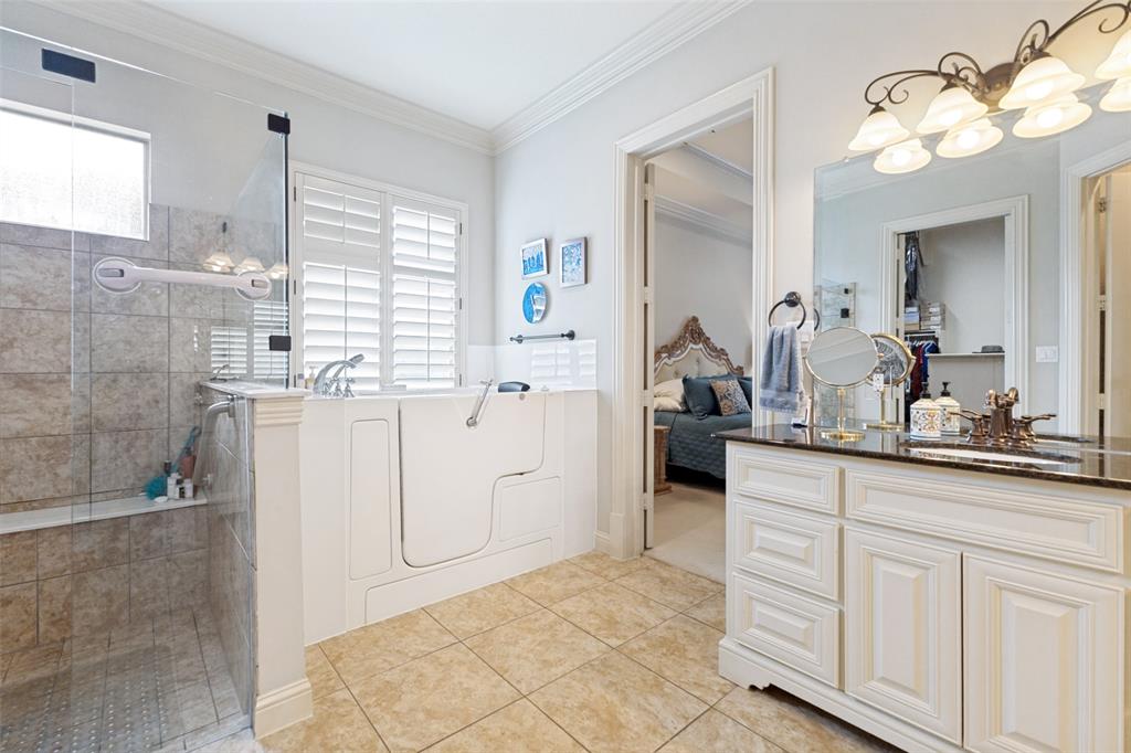 971 Elk Ridge Road Prosper, TX 75078 - Photo 15 of 29 Great natural light fills the space, complemented by plantation shutters over the easy-access bath.