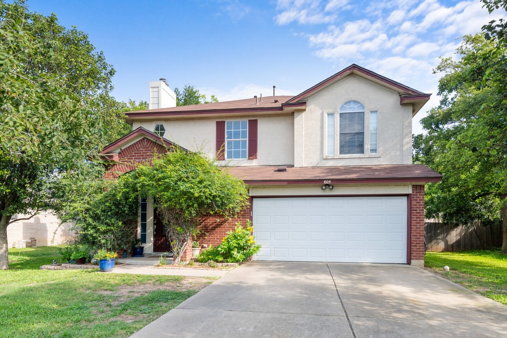 605 Caballero Road Leander, TX 78641 - Photo 1 of 1 a front view of a house with a yard and potted plants