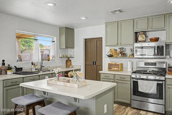 a kitchen with stainless steel appliances a sink stove and refrigerator